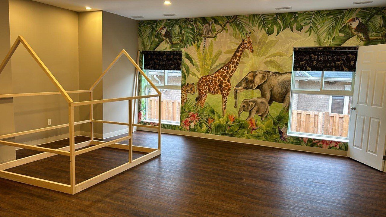A room with a wooden bed and a mural of animals on the wall.