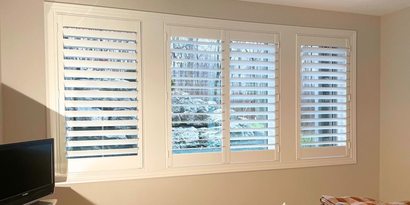 An image of locally-made shutters installed in a bedroom by Signature Shutters & Blinds