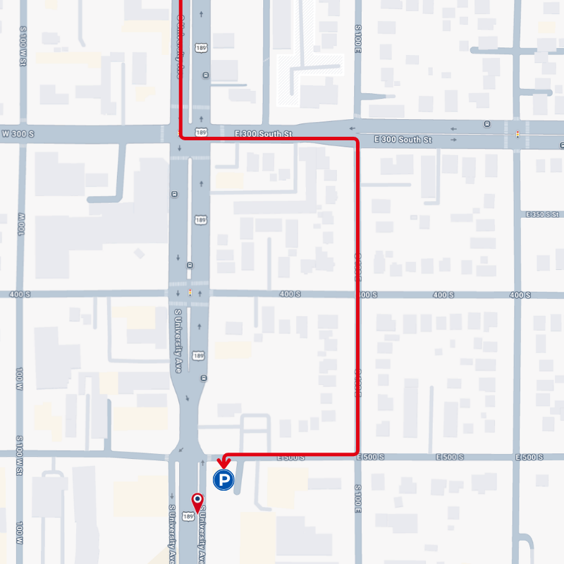 Map with a red route line leading to a blue parking icon on city streets.