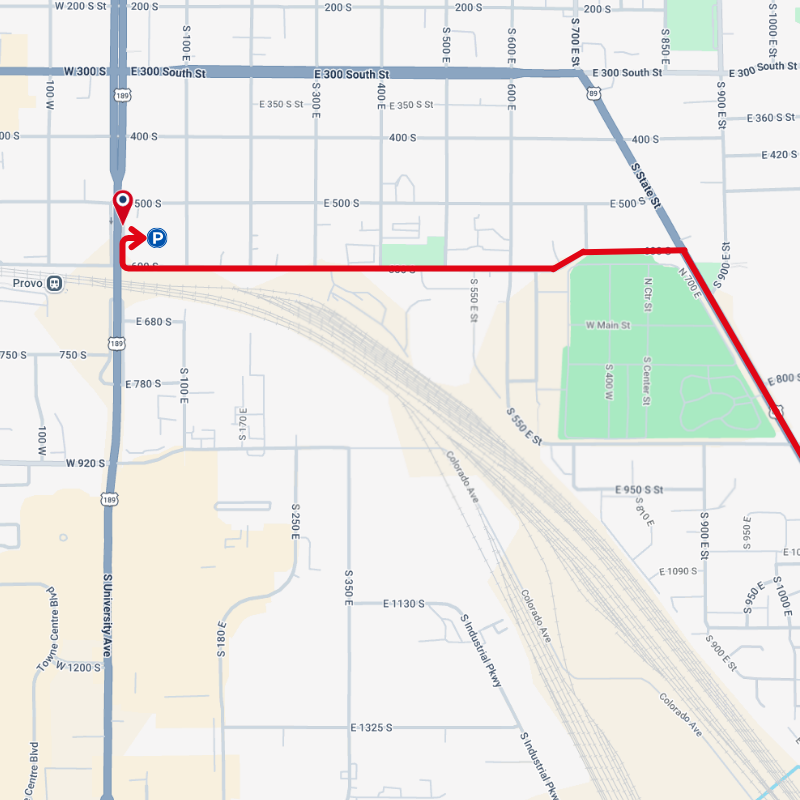 Map with a red route line along streets, turning near a green park area.