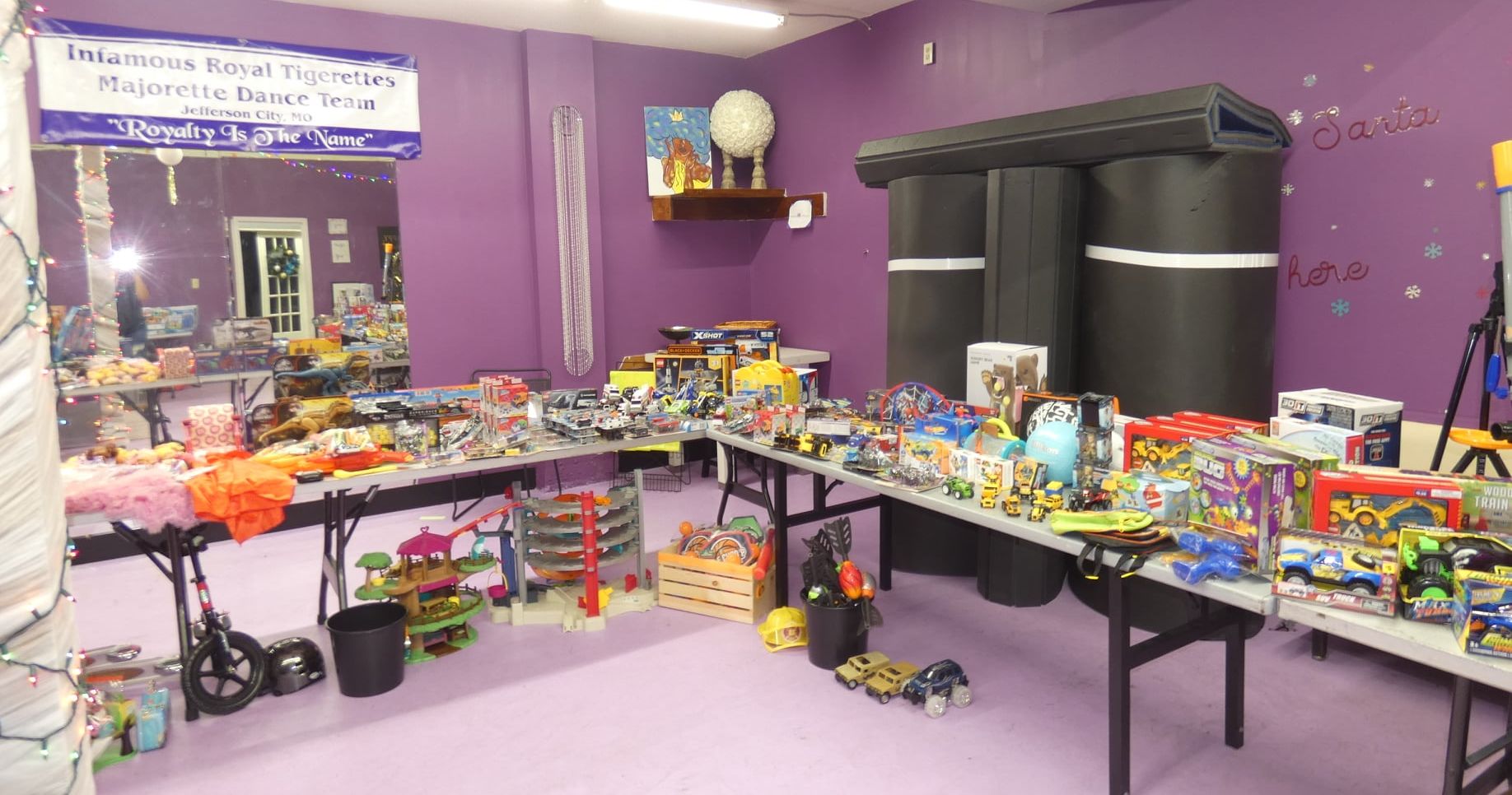 A room filled with lots of toys on tables.