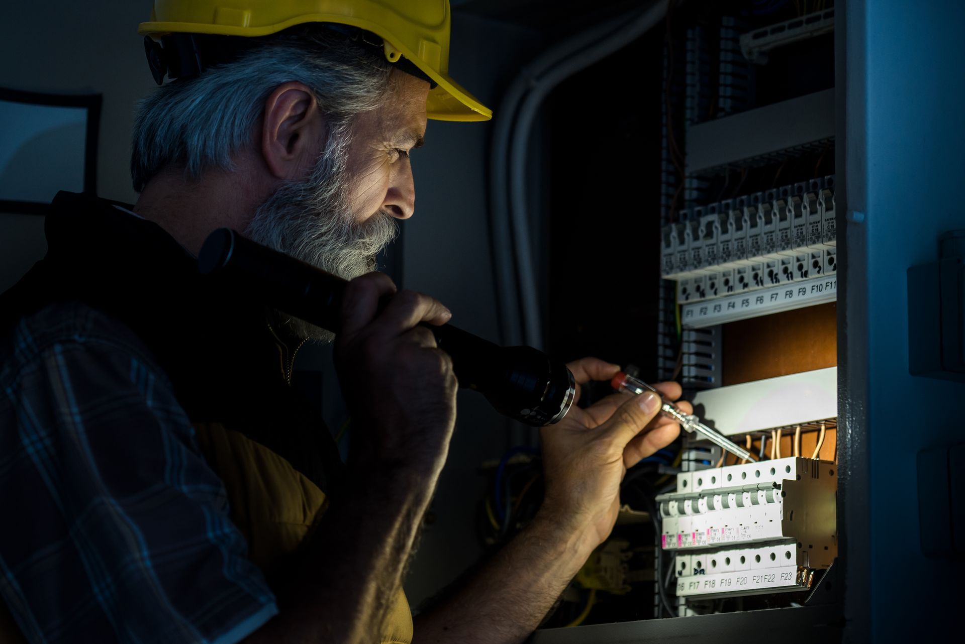 Electrician repairing electric panel.