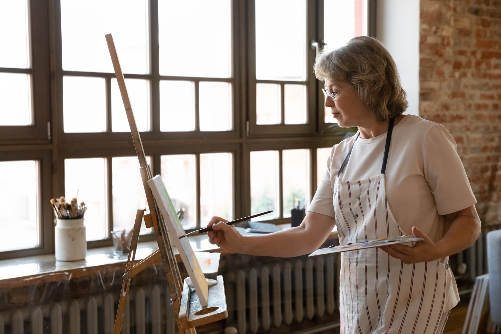 An eldery white woman takes a painting class, she asks herself the question