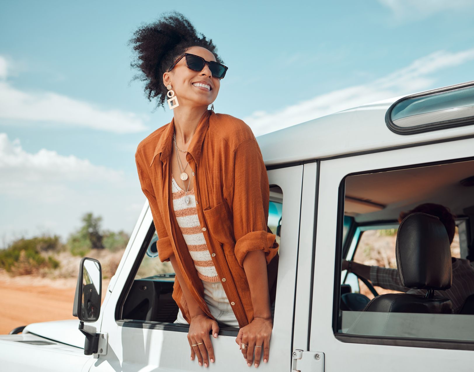 the woman holds her head out of the window having found the difference between destination vs journey
