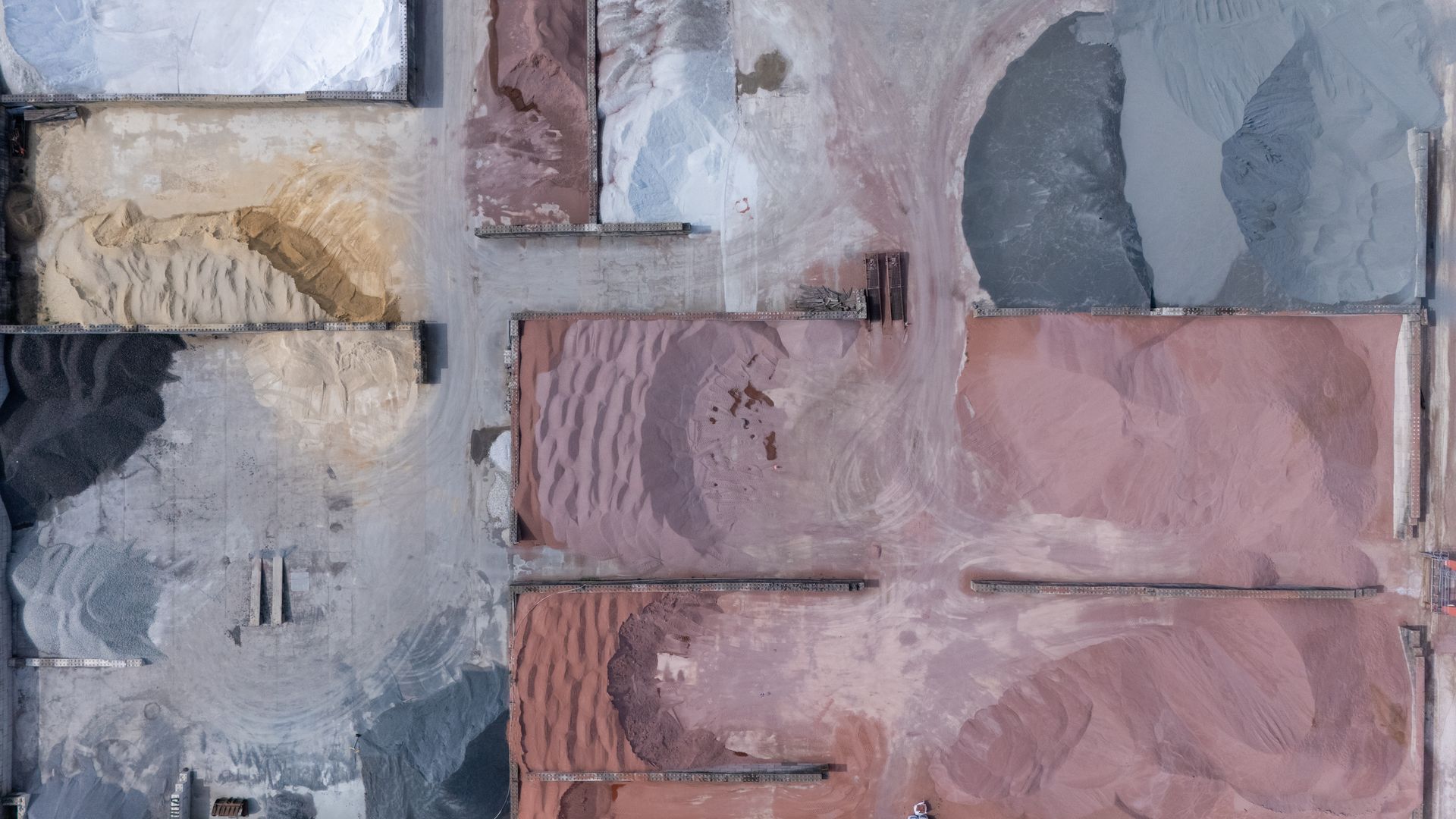 Abstract close-up of stacked stone or tile blocks in gray, pink, and tan tones