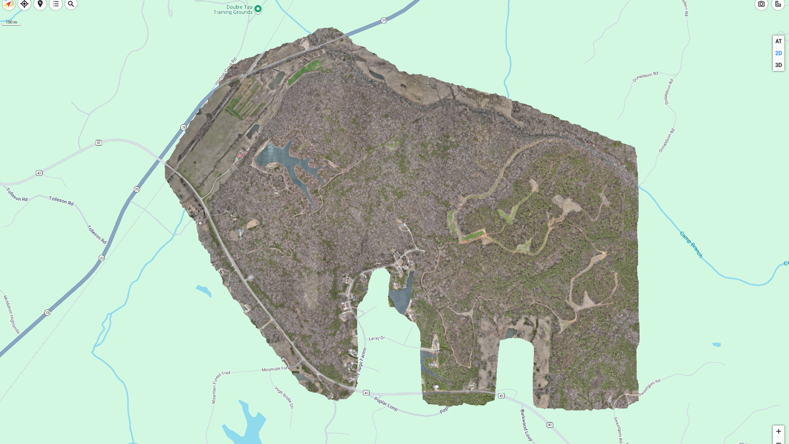 Aerial map view of a large brown elephant-shaped land area beside pale green water