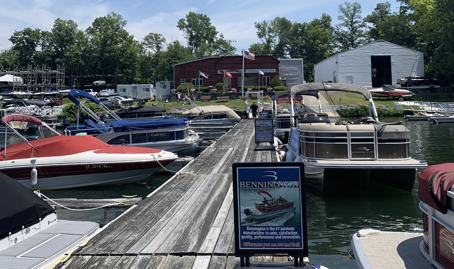 A dock filled with boats and a sign that says boat rental.