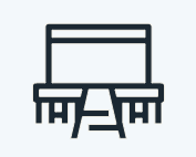 A black and white icon of a table and chairs on a white background.