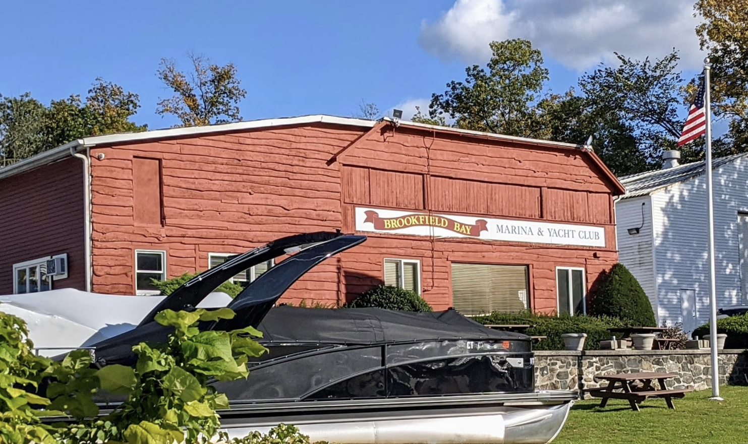 A boat is parked in front of a brick building.