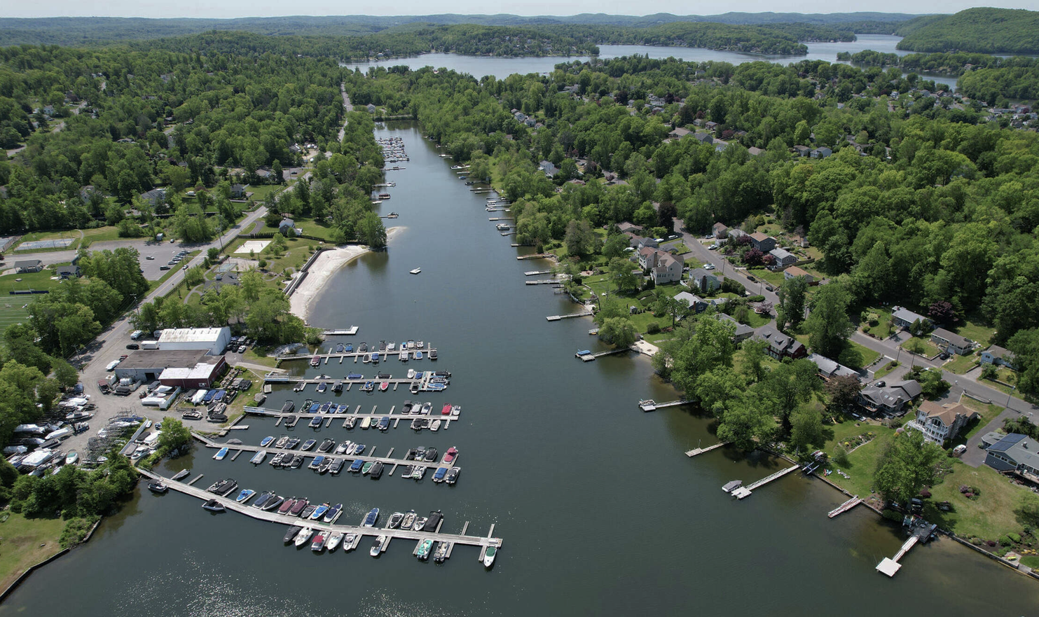 An aerial view of a lake with boats docked in it