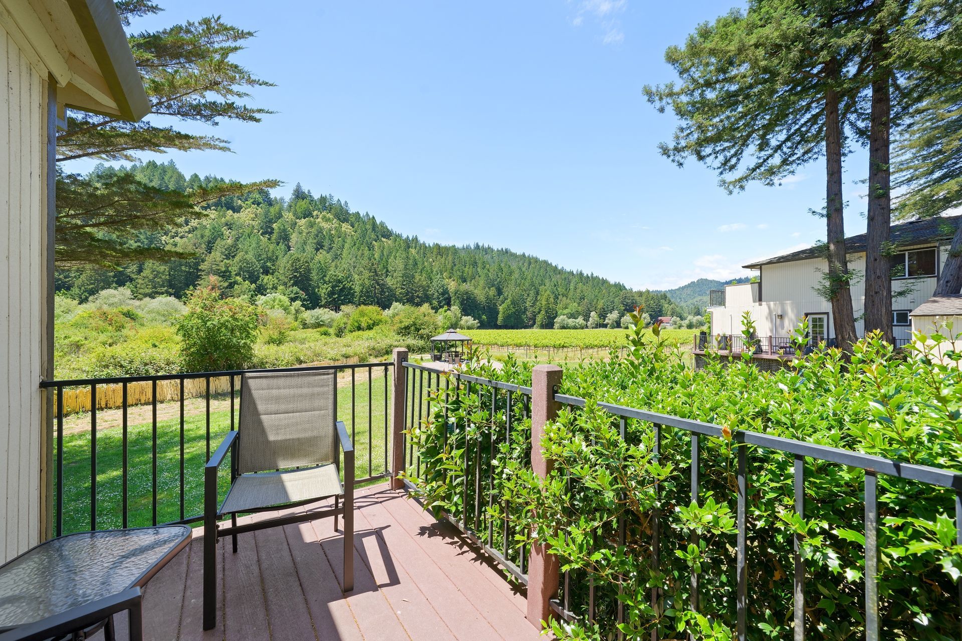 Two Queen Deluxe Suite Patio with chair and umbrella