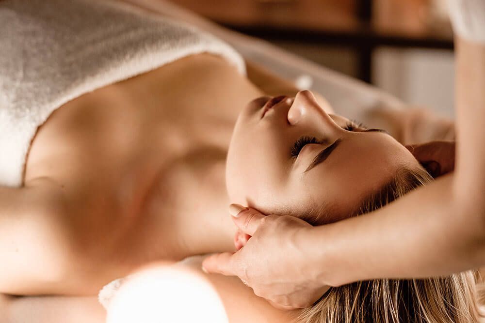 Woman laying down in a spa setting.