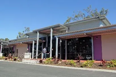A purple and white building with a blue sky in the background