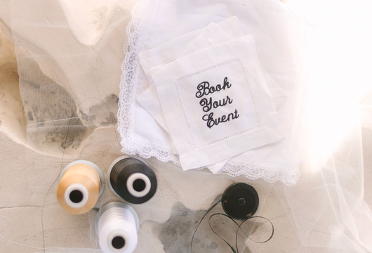 Three realistic glass eyes on white tulle with a small embroidered tag reading “Look Your Eyes”