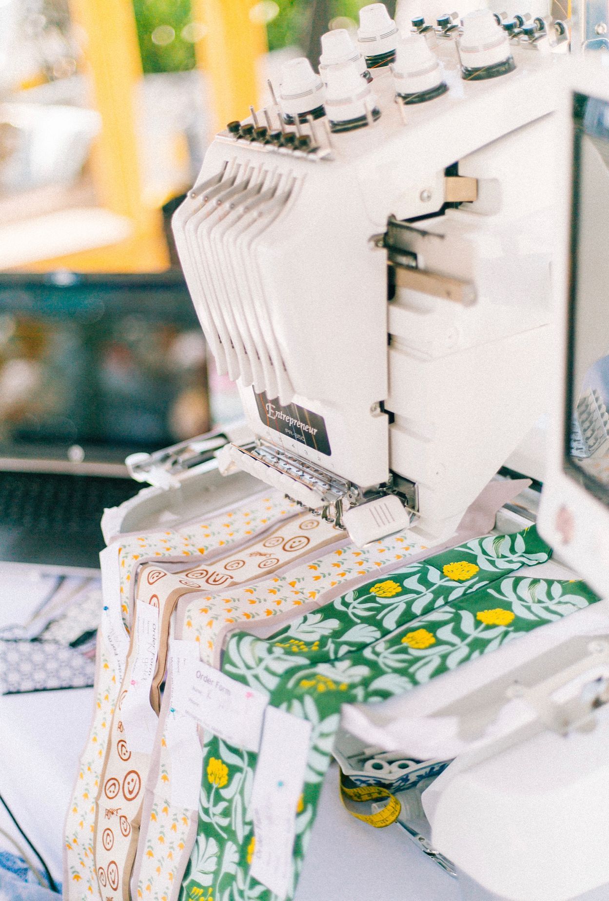 Industrial sewing machine stitching colorful patterned fabric