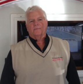 An older man wearing a vest and a black shirt