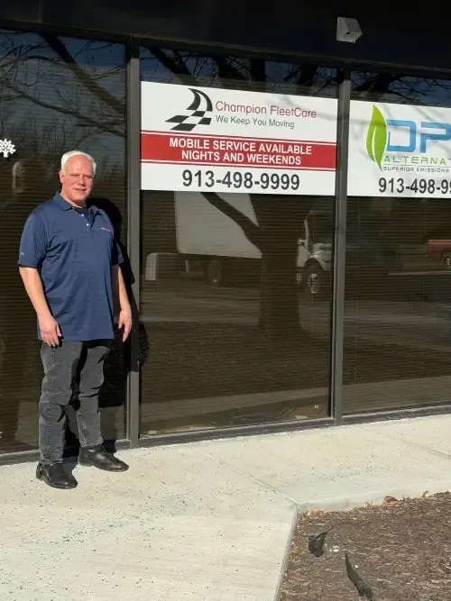 Man standing outside a storefront with a Chattanooga Fire Company sign and phone number visible.