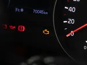 Car dashboard with warning lights on and speedometer at 0 mph