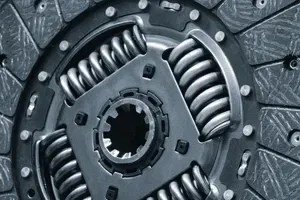 Close-up of a metal clutch disc with coiled springs and gear teeth detail