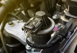 Close-up of an electrical connector and wire harness on an engine component