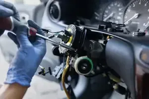 Mechanic using a screwdriver to adjust a car dashboard instrument cluster during repair