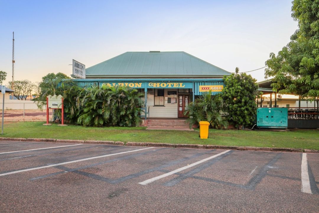 A Large Building With a Green Roof and a Parking Lot in Front of It — Outback Auctions and Real Estate in Cloncurry, QLD