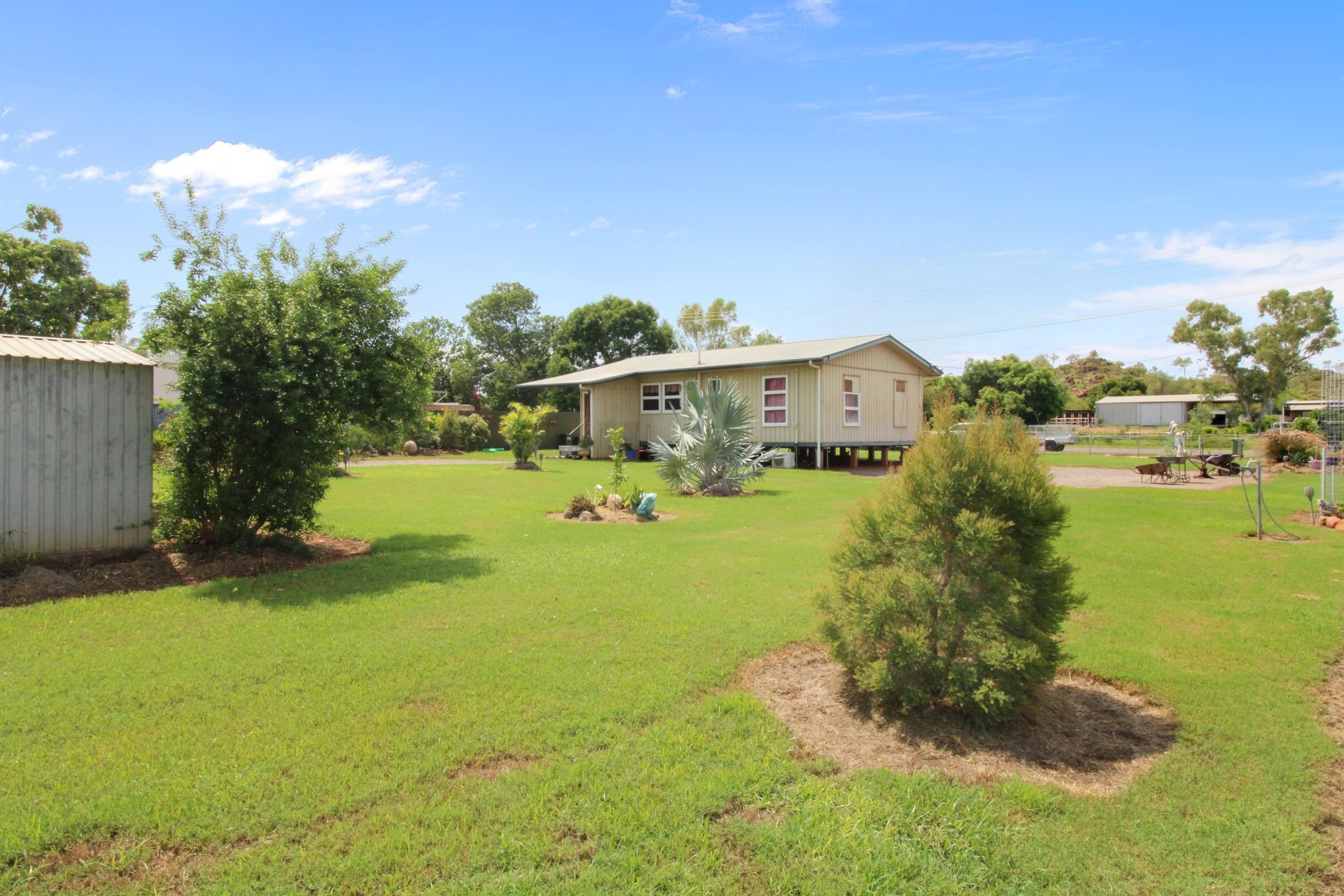 A House is Sitting in the Middle of a Lush Green Field — Outback Auctions and Real Estate in Cloncurry, QLD
