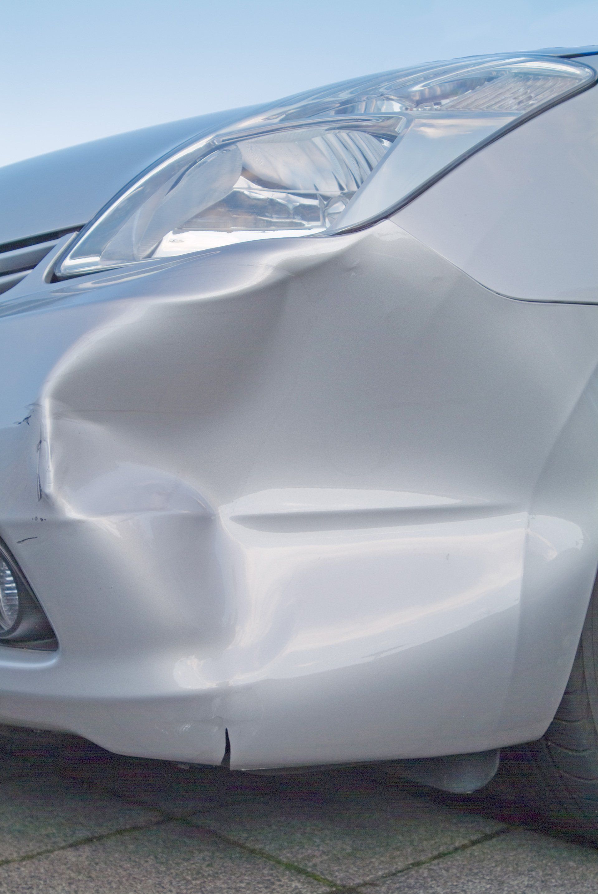 A dent in the right front quarter of a european car