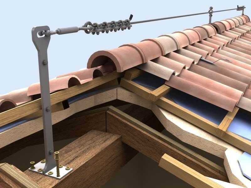 Ancoraggio per tetto e fune di sicurezza installati su un tetto di tegole vicino al colmo