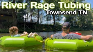 A man and a child are floating down a river in green tubes.