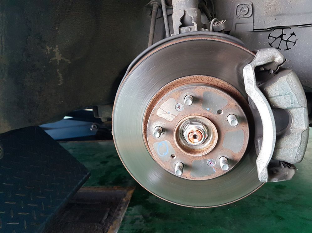 A Close Up Of A Brake Disc On A Car — Total Auto Service In Caloundra West, QLD