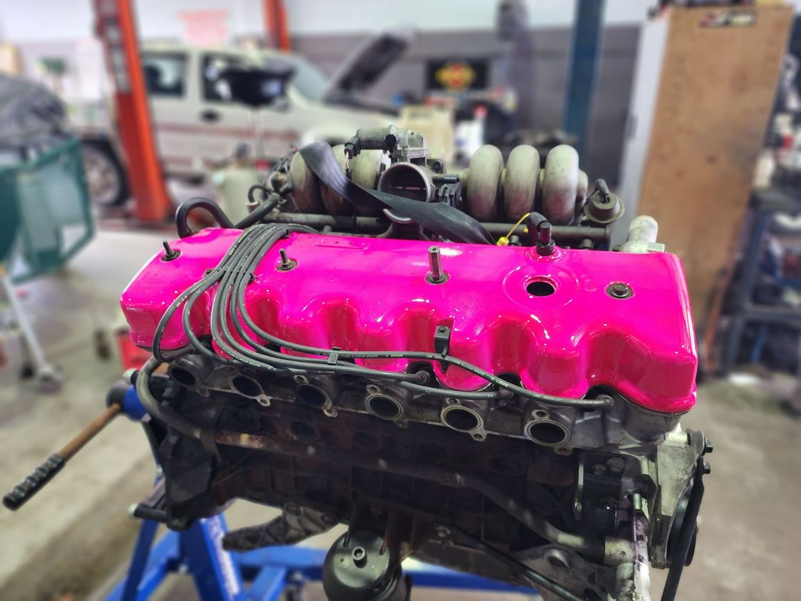 Pink Power Steering Fluid Cap Maintained by a Mechanic in Caloundra — Total Auto Service In Caloundra West, QLD