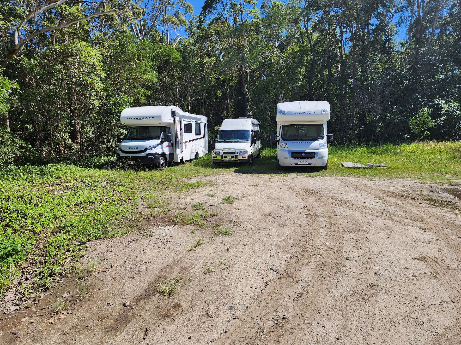 Three White Rvs Parked on a Dirt — Total Auto Service In Caloundra West, QLD