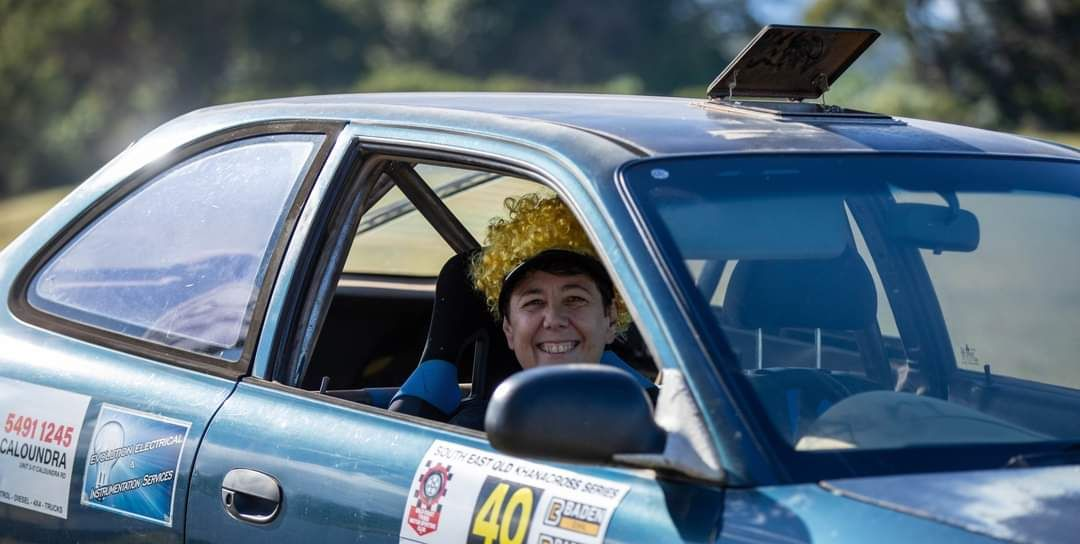 Driver Smiling in a Blue Race Car — Total Auto Service In Caloundra West, QLD