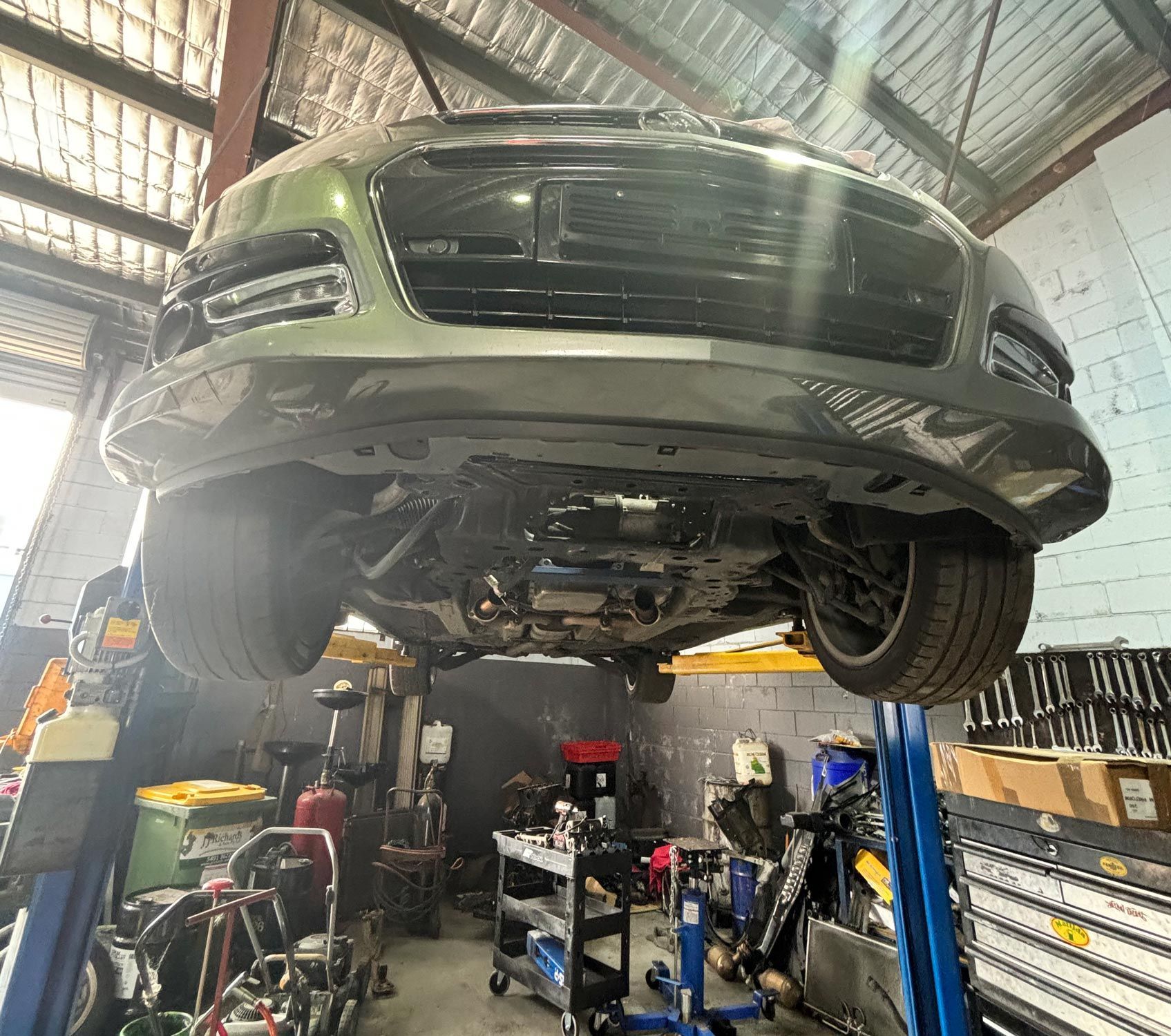 Car Raised on a Lift in a Workshop, Viewed From Underneath — Total Auto Service In Caloundra West, QLD