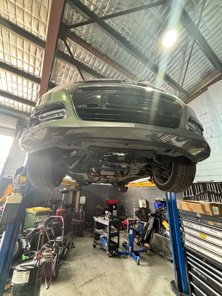Vehicle in A Post Lifter — Total Auto Service In Caloundra West, QLD