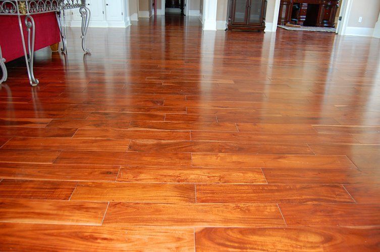 Polished, warm-toned hardwood flooring extending through a brightly lit interior space.