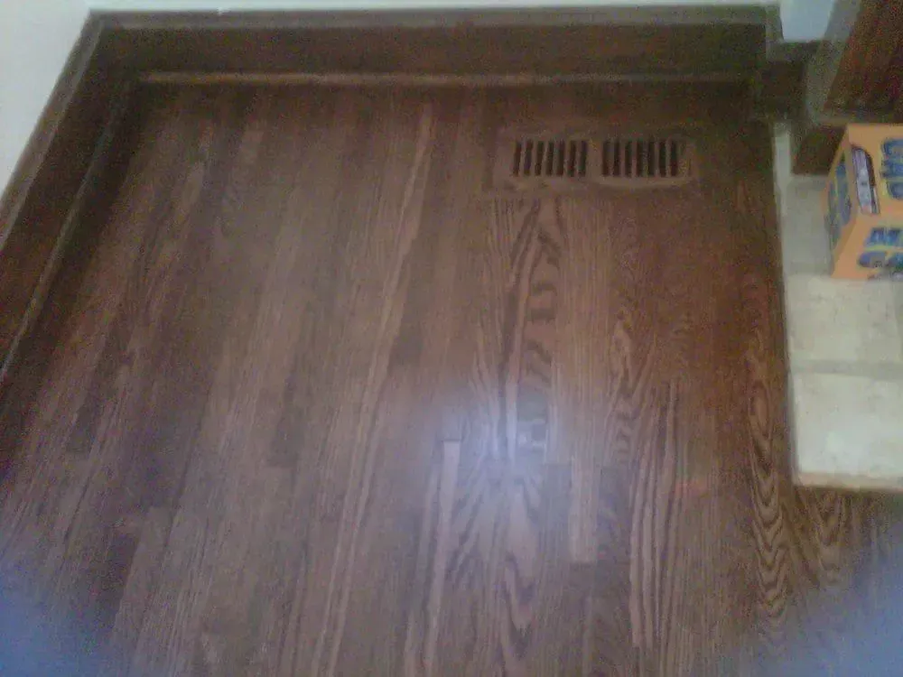 Wooden floor hatch with a small vent near the top right corner