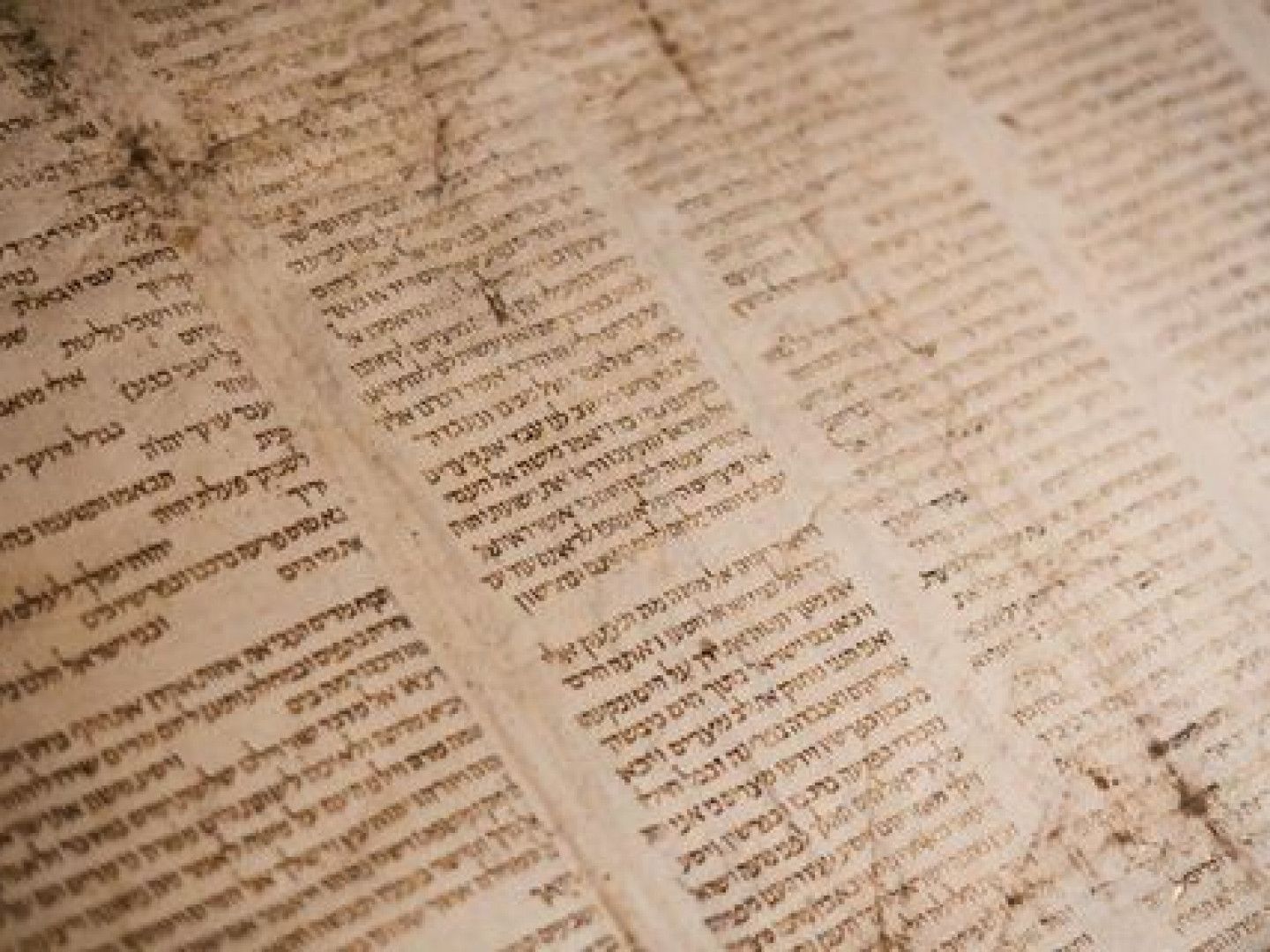Close-up of aged handwritten manuscript pages with dense text, slightly yellowed and worn.