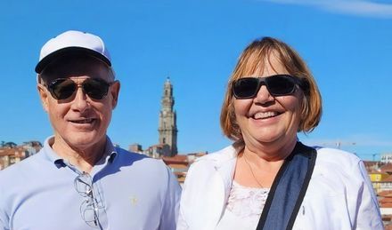 A man and a woman in sunglasses smiling together

