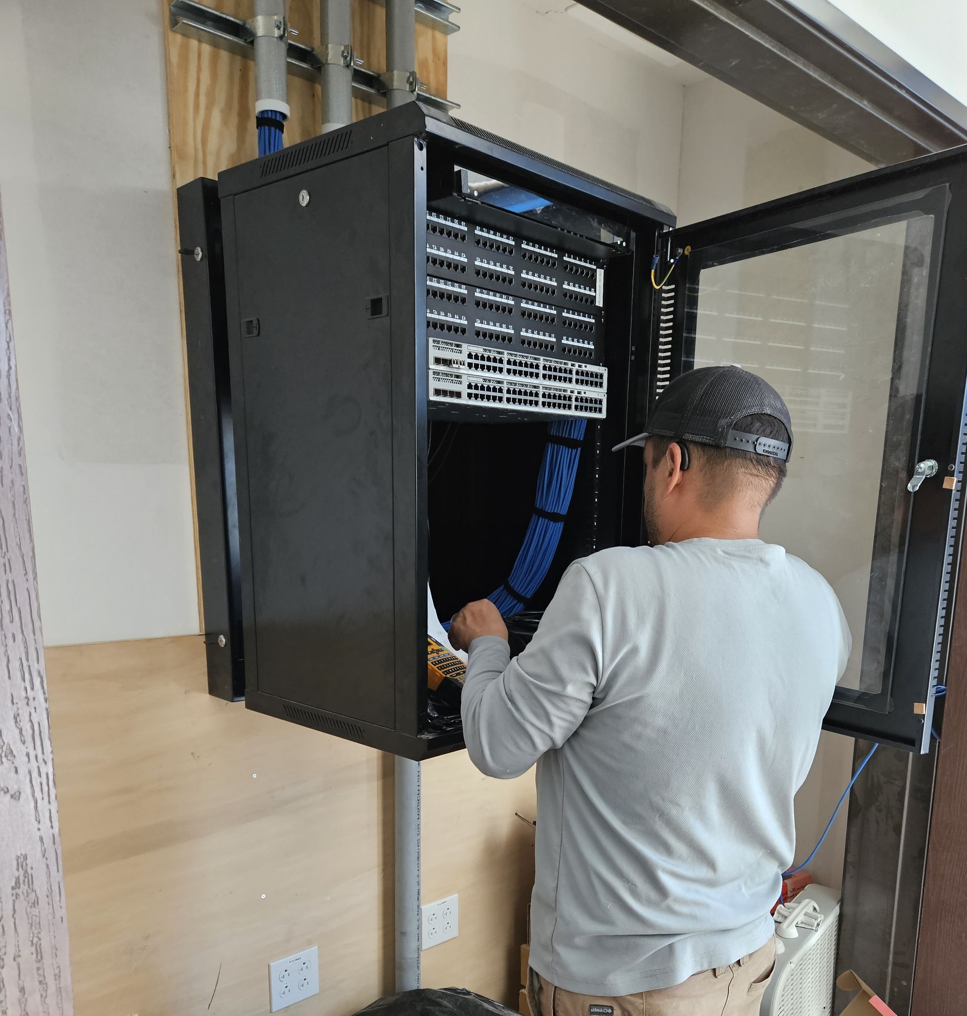 Technician reviewing access control panel and camera coverage plan