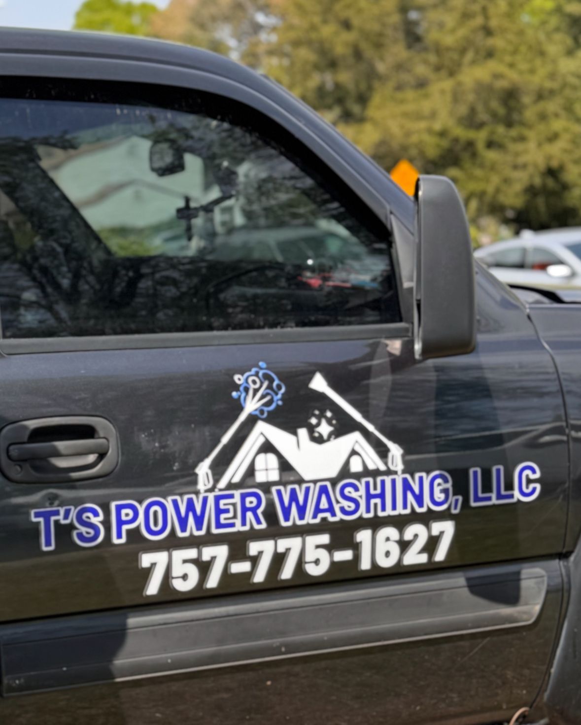 A black truck with t 's power washing llc written on the side