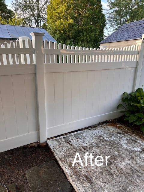 A picture of a white fence after being cleaned.