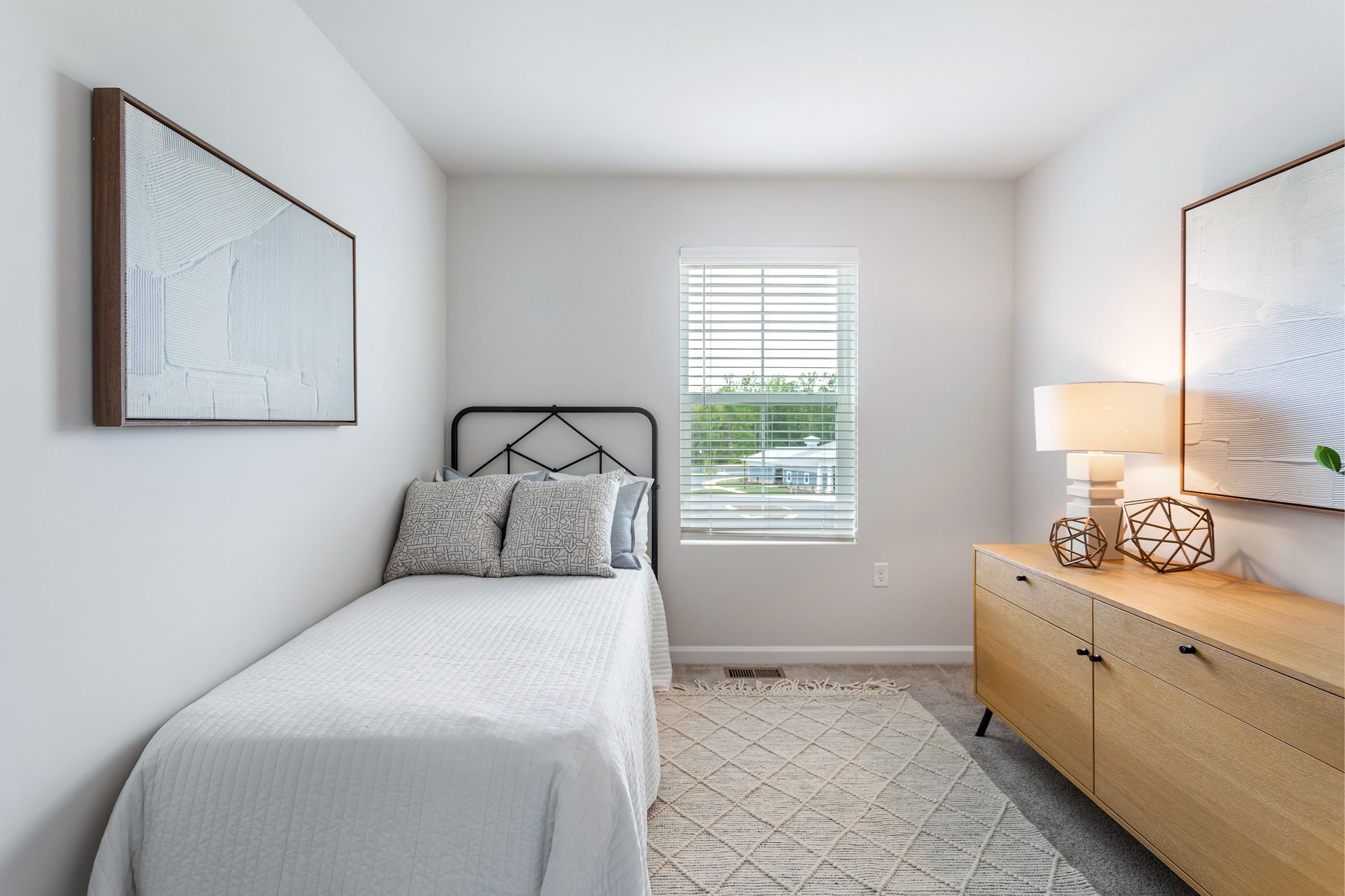 A bedroom with a single bed and a window.