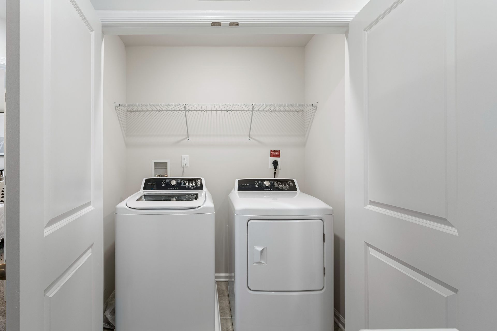 A laundry room with a washer and dryer in a closet.