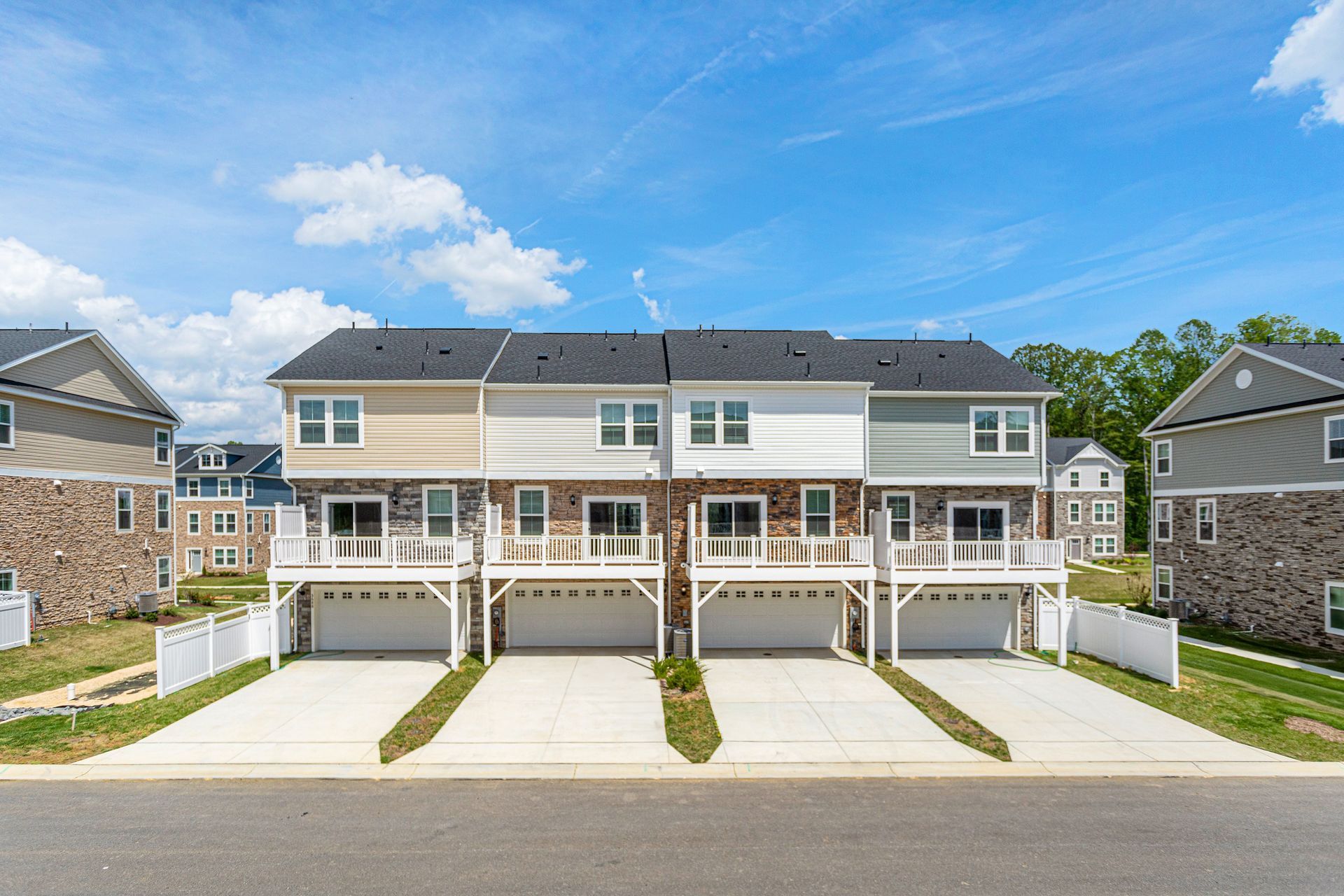 A row of houses with three garages in a residential area.