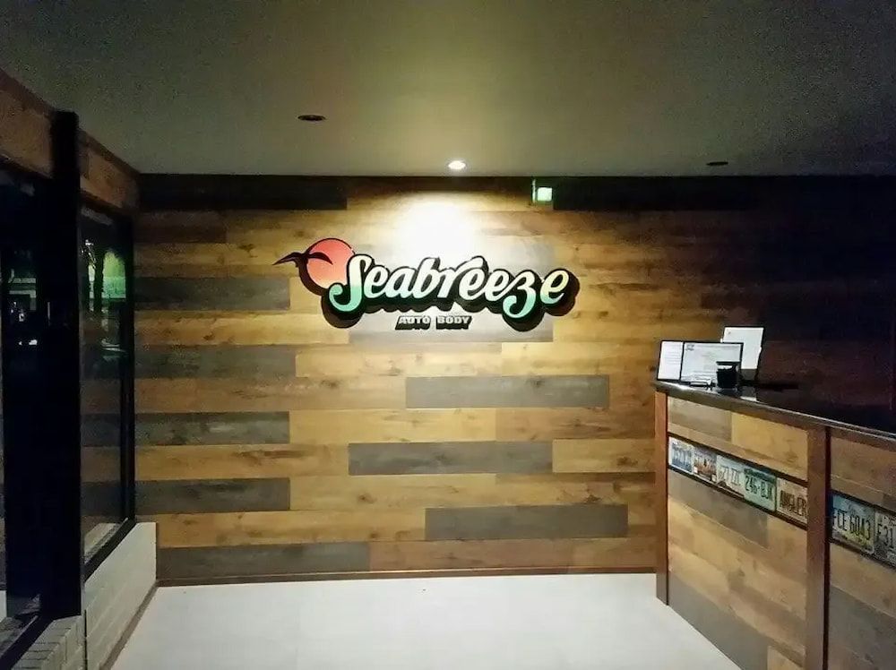 A Restaurant With a Wooden Wall and a Sign That Says Seabreeze — Seabreeze Auto Body in Coffs Harbour, NSW