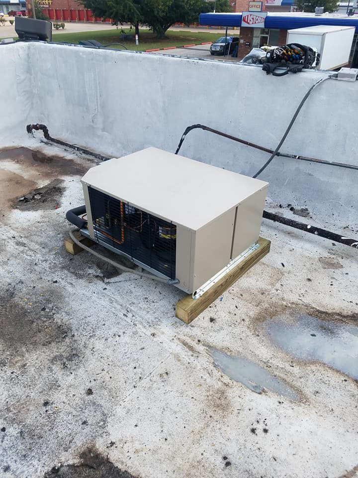 A box is sitting on the roof of a building.