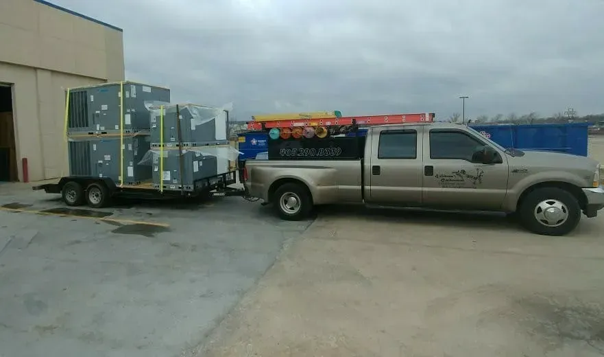 A truck is pulling a trailer with boxes on it.