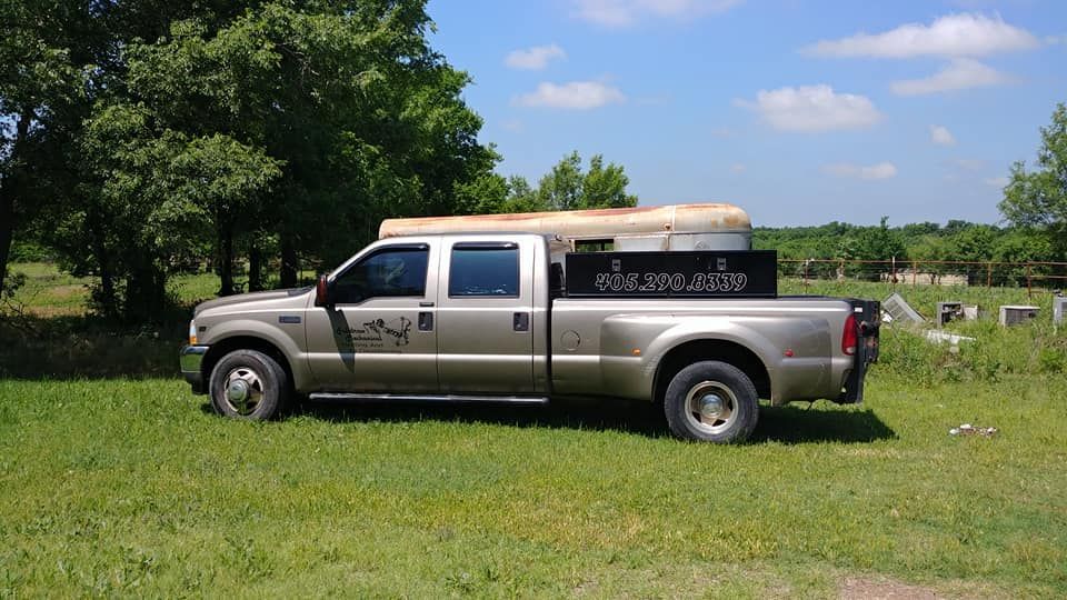 A pickup truck is parked in a grassy field